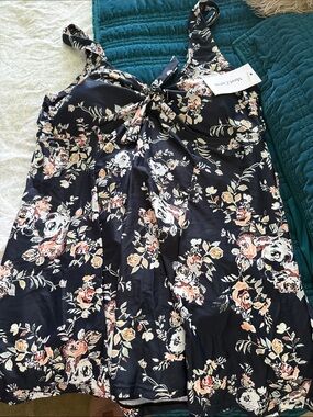 Beautiful One Piece Swim Suit. Dress style with Built In Bottoms. NWT